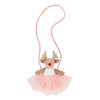 Stuffed reindeer toy with a pink skirt on a white background