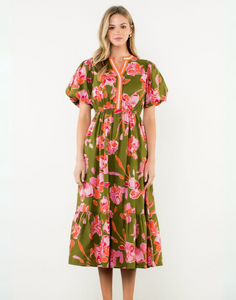 Woman wearing a floral dress with a green background