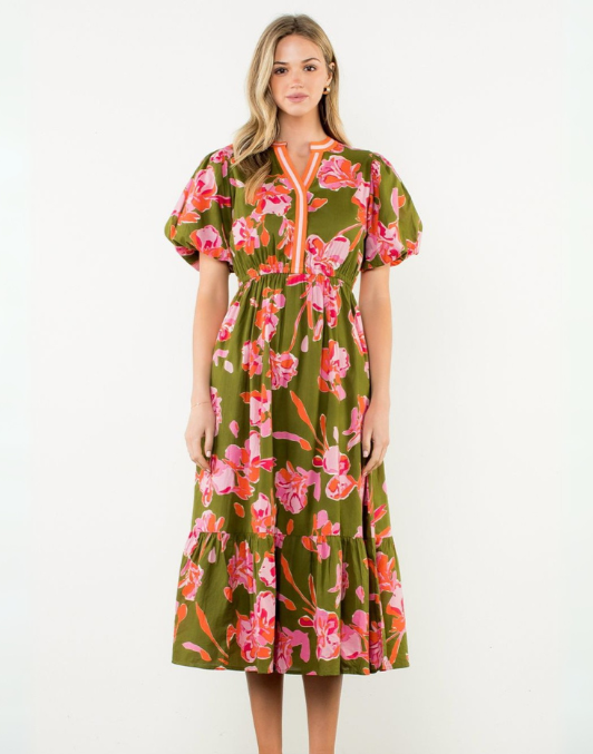 Woman wearing a floral dress with a green background